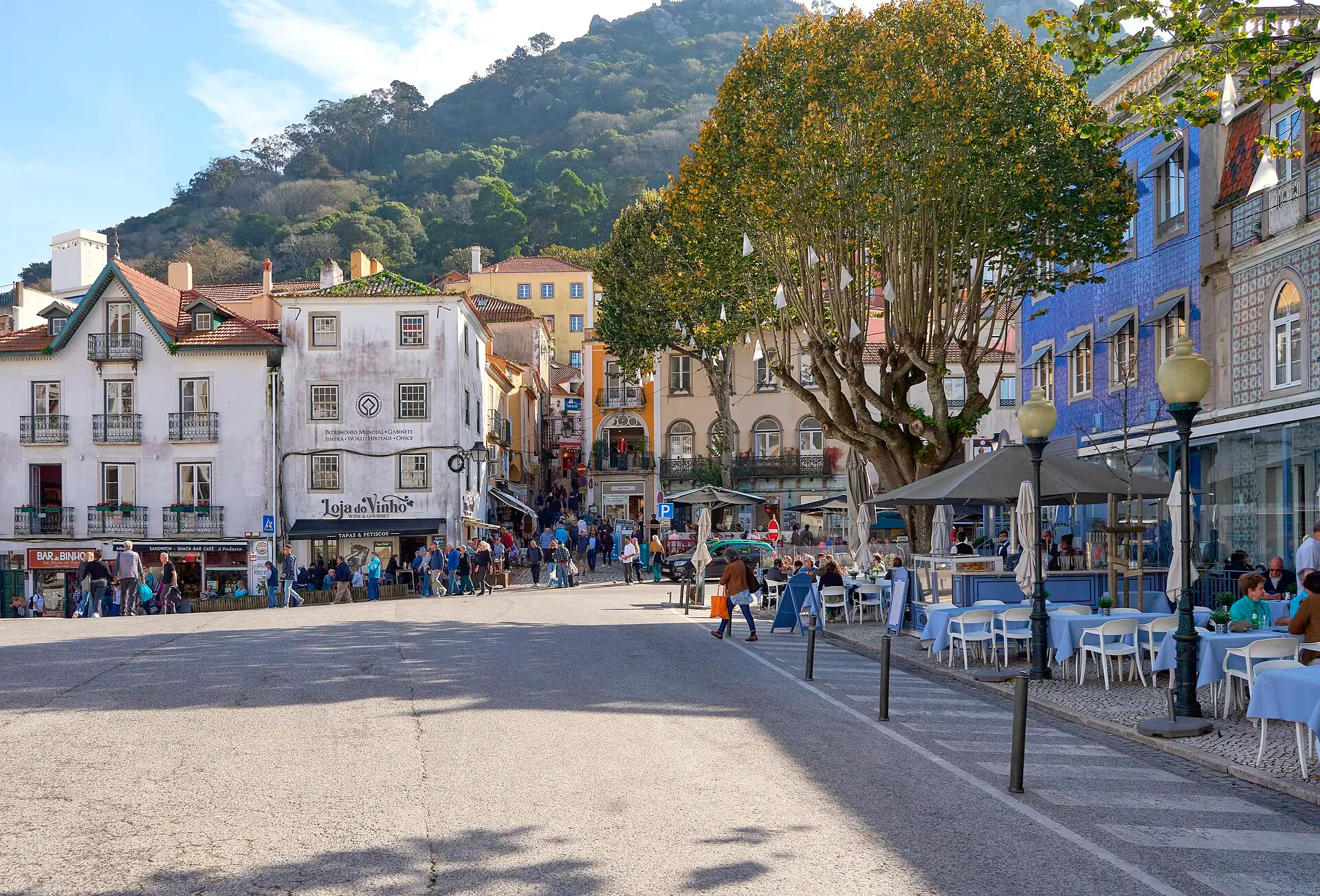 The main square of Sintra with cafe terraces and the hill above